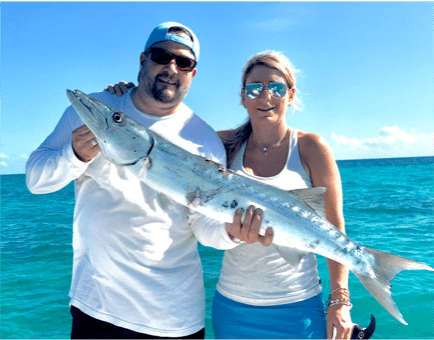 Man and woman holding a Barracuda