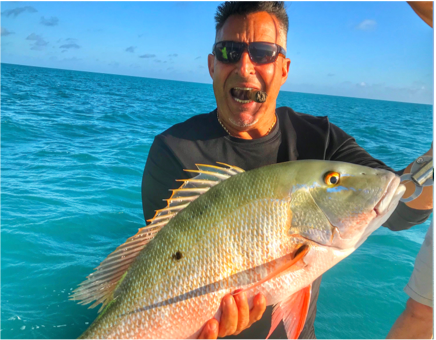 Man posing with Mutton Snapper