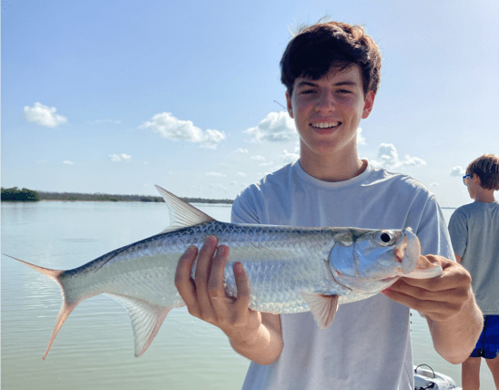 Male teenager holding a fish